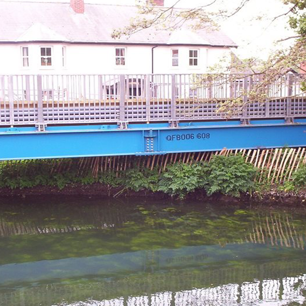 MH International pedestrian beam bridge on site over river